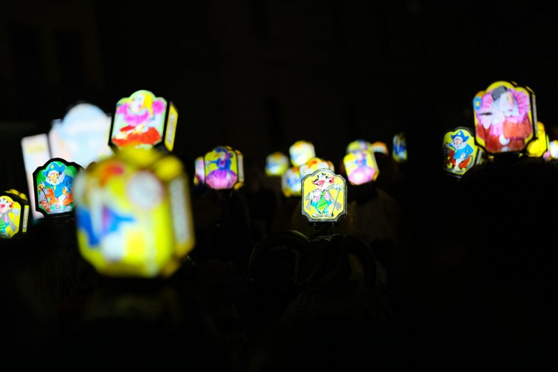 Glowing Fasnacht lanterns carried through Basel in the dark.