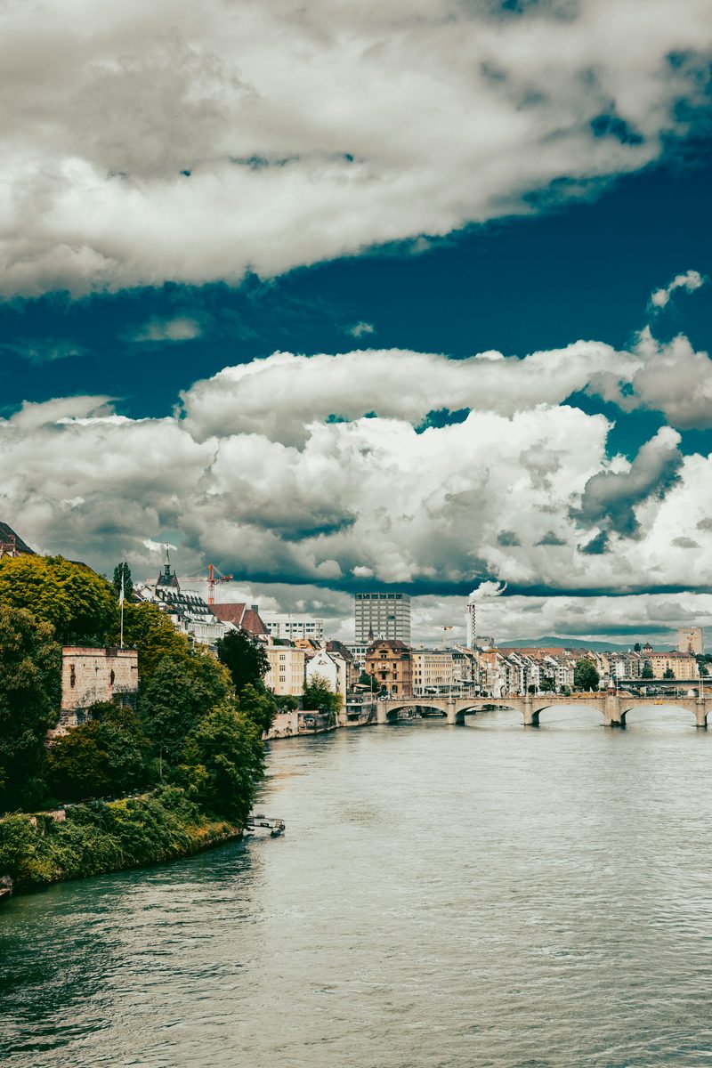 The Rhine and the Mittlere Brücke in Basel under a summer sky.