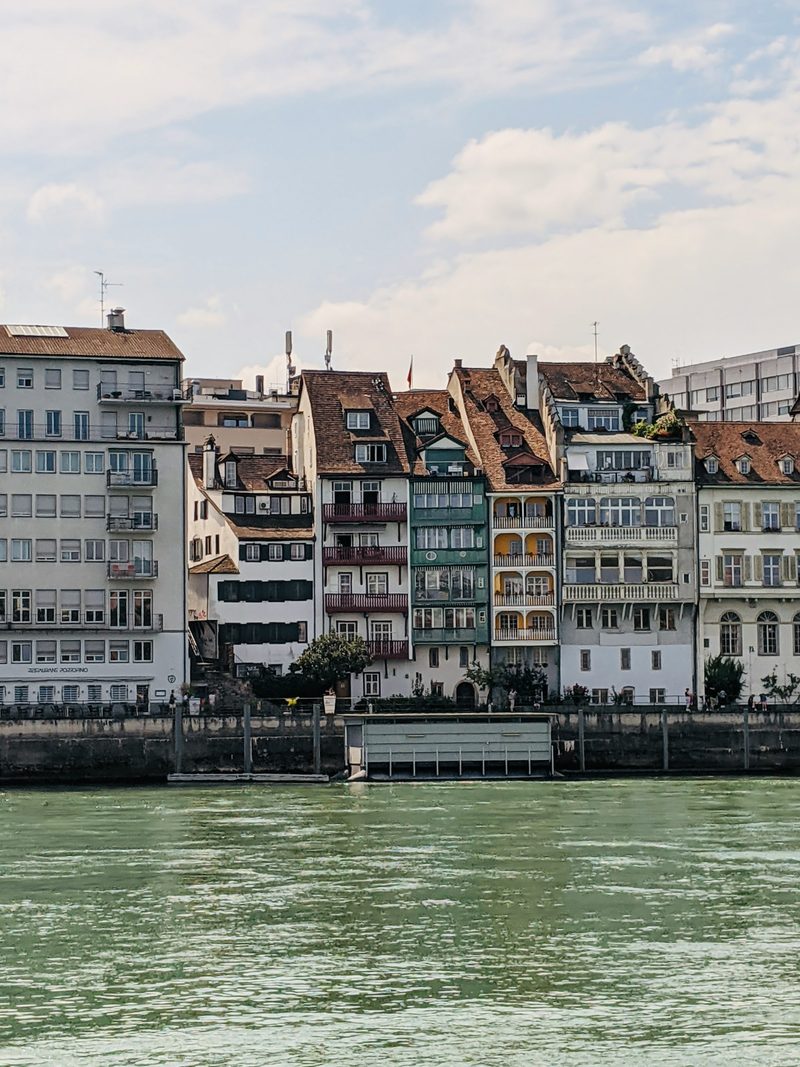 Tall historic houses lining the Rhine in Basel.